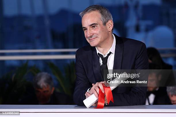 Director Olivier Assayas poses after being awarded the Best Director prize for the movie 'Personal Shopper' during the Palme D'Or Winner Photocall...