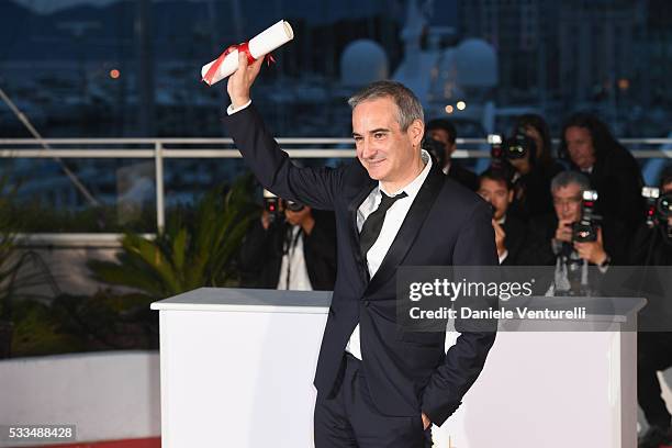 Director Olivier Assayas poses after being awarded the Best Director prize for the movie 'Personal Shopper' during the Palme D'Or Winner Photocall...