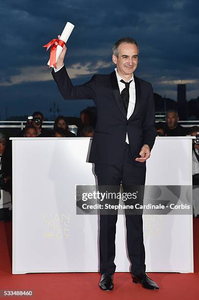 Director Olivier Assayas poses after being awarded the Best Director prize for the movie 'Personal Shopper' during the Palme D'Or Winner Photocall...