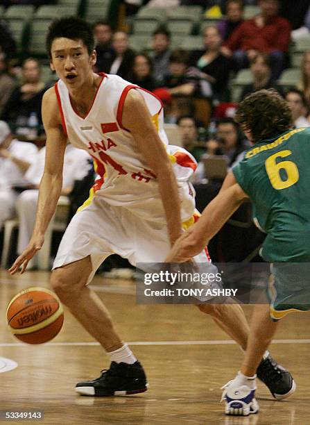 Chinese basketball player, Sun Yue dribbles past Australian guard Peter Crawford during their game at Challenge Stadium in Perth, 10 August 2005....