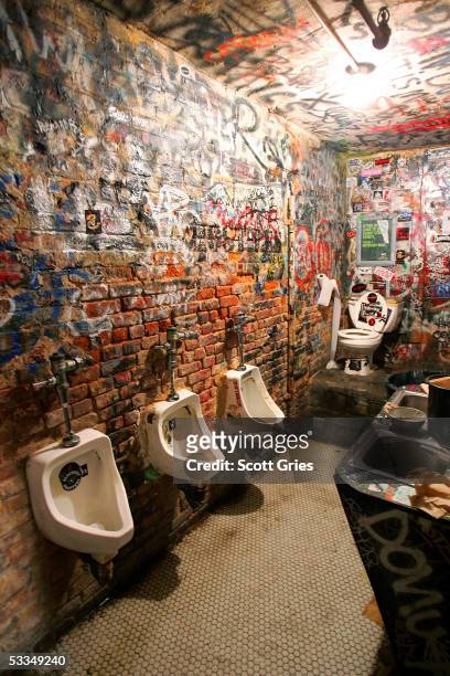 The graffitied bathroom walls of legendary punk rock club CBGB's are seen during the last month of its current lease August 10, 2005 in New York...