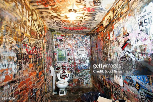 The graffitied bathroom walls of legendary punk rock club CBGB's are seen during the last month of its current lease August 10, 2005 in New York...