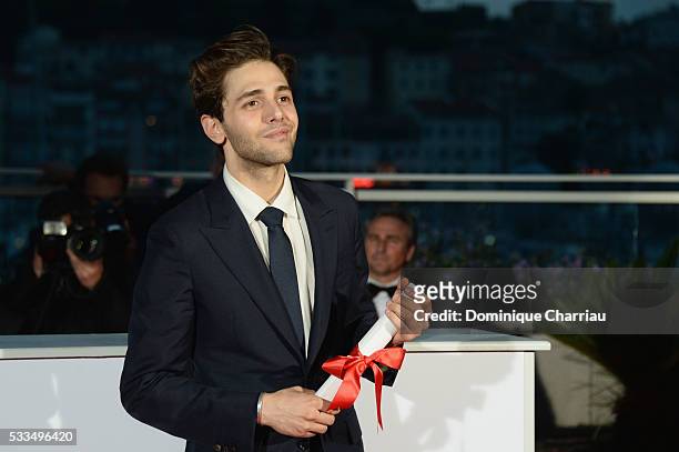 Director Xavier Dolan poses after being awarded The Grand Prix for the movie 'Just the end of the world' during the Palme D'Or Winner Photocall...