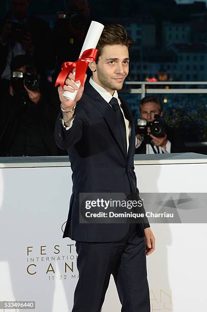 Director Xavier Dolan poses after being awarded The Grand Prix for the movie 'Just the end of the world' during the Palme D'Or Winner Photocall...