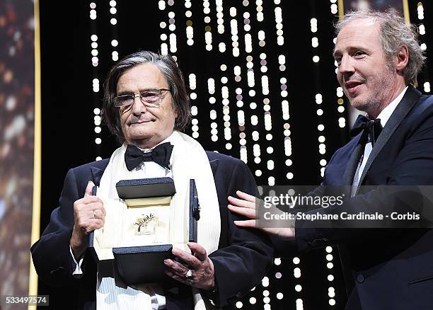 Director Jean-Pierre Leaud receives The Honorific Palme d'Or from jury member Arnaud Desplechin during the Closing Ceremony at the annual 69th Cannes...