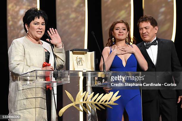 Actress Jaclyn Jose delivers a speech next to actress Andi Eigenmann and director Brillante Mendoza after being awarded with the Best Actress prize...