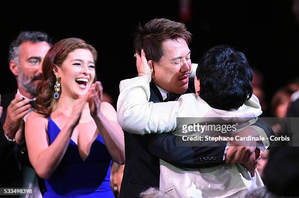 Actress Jaclyn Jose hugs director Brillante Mendoza next to actress Andi Eigenmann and after being awarded with the Best Actress prize during the...