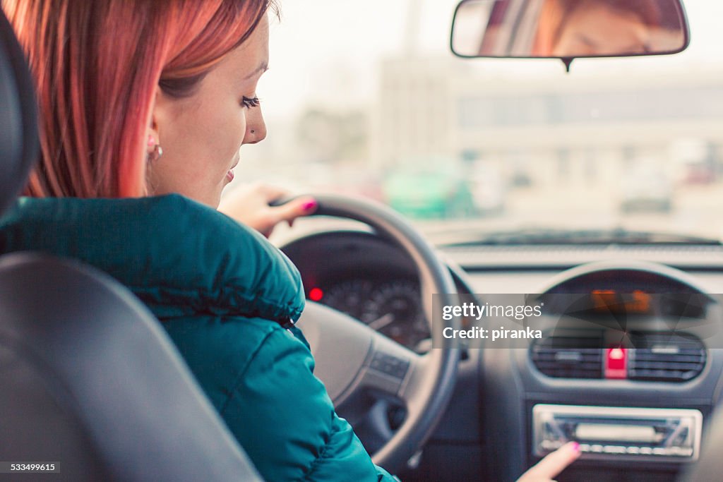 Young driver changing radio stations