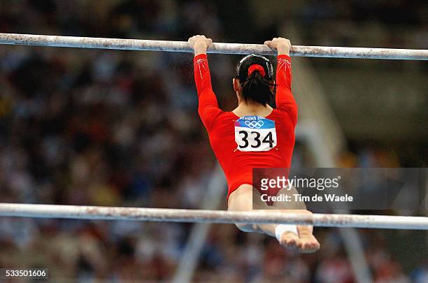 Li Lin competes in the Women's Asymmetric Bars Final at the 2004 Athens Olympic Games. Lin finished in seventh place in the event.
