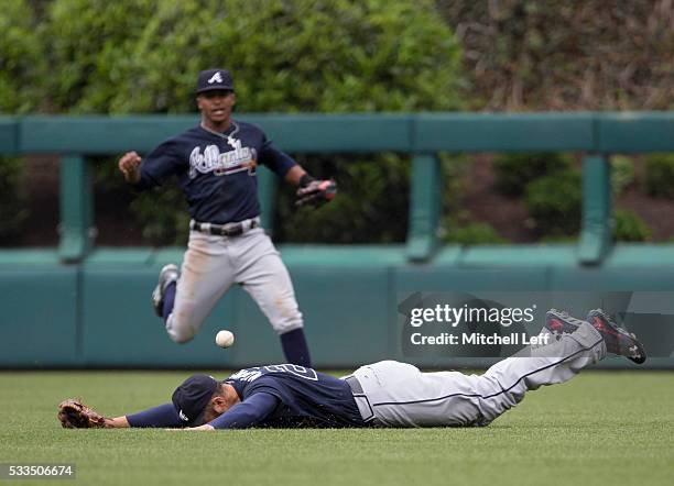 Nick Markakis of the Atlanta Braves cannot make the diving catch on a ball hit by Maikel Franco of the Philadelphia Phillies in the bottom of the...