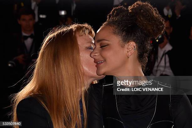 British director Andrea Arnold kisses US actress Sasha Lane during a photocall after she was awarded with the Jury Prize for the film "American...