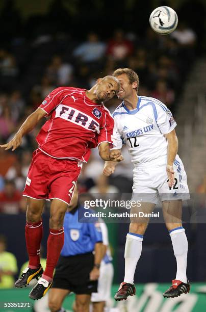 Brown of the Chicago Fire and Jimmy Conrad of the Kansas City Wizards collide head-to-head while battling for the ball on August 10, 2005 at Soldier...