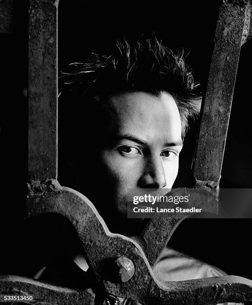 Keanu Reeves Standing Behind Metal Crosspiece