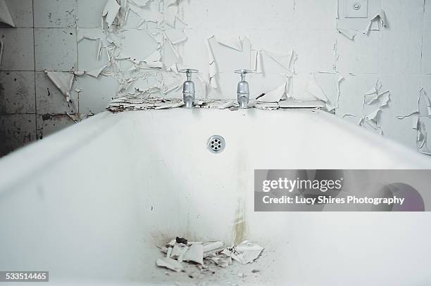 white bath with white peeling paint and tiles - lucy shires stockfoto's en -beelden