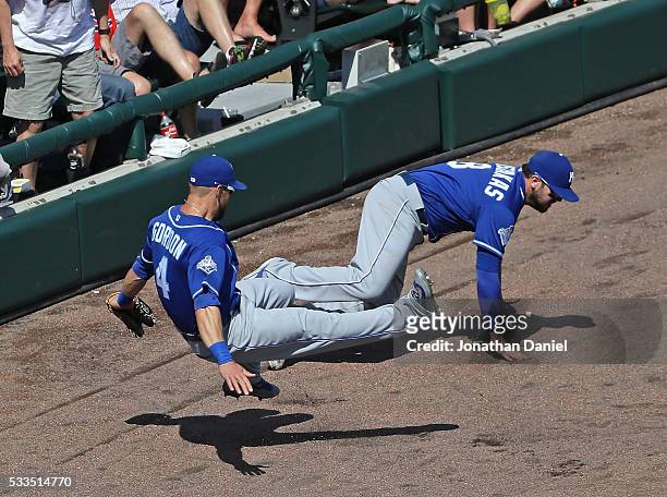 Alex Gordon and Mike Moustakas of the Kansas City Royals collide going for a foul ball against the Chicago White Sox at U.S. Cellular Field on May...