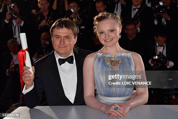Romanian director Cristian Mungiu poses with Romanian actress Maria Dragus after he was awarded with the Best Director prize for the film "Graduation...