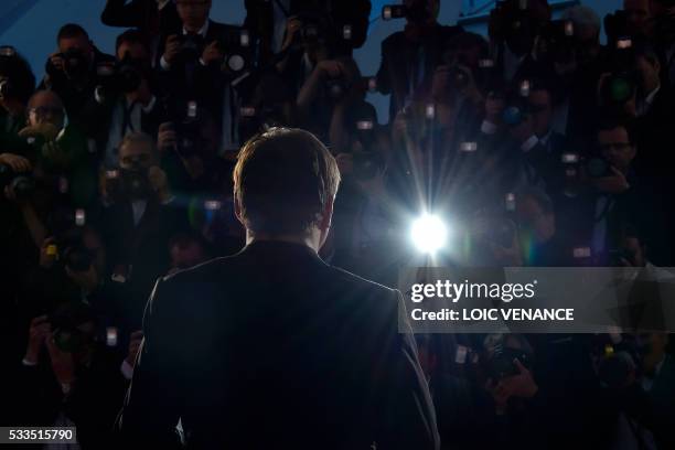 Romanian director Cristian Mungiu poses with his trophy during a photocall after he was awarded with the Best Director prize for the film "Graduation...