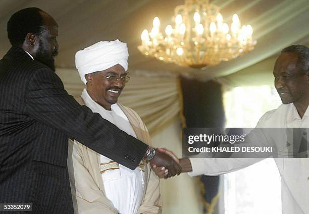 Leader of the Sudan People's Liberation Movement , Salva Kiir , shakes hands with Sudan's second Vice President Ali Osman Taha as President Omar...