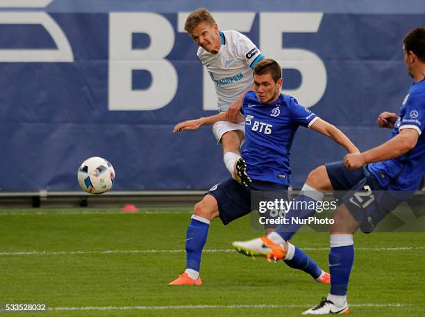 Oleg Shatov of FC Zenit St. Petersburg shoots the ball as Aleksandr Tashayev of FC Dynamo Moscow and Fatos Beciraj of FC Dynamo Moscow defend during...