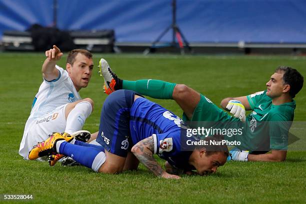 Artem Dzyuba of FC Zenit St. Petersburg, Andrey Yeshchenko of FC Dynamo Moscow and Vladimir Gabulov of FC Dynamo Moscow react on a scored goal during...