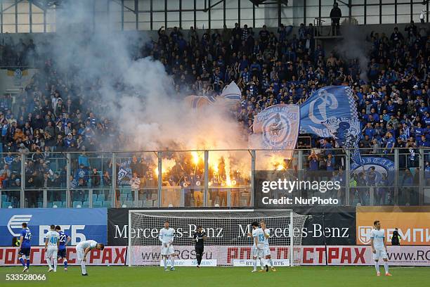 Dynamo Moscow supporters light flares during the Russian Football Premier League match between FC Dynamo Moscow and FC Zenit St. Petersburg at Arena...