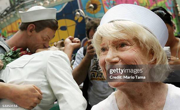 Eighty six-year-old Edith Shain stands in Times Square beside a statue of her famous kiss with a sailor on V-J Day at the end of World War II August...