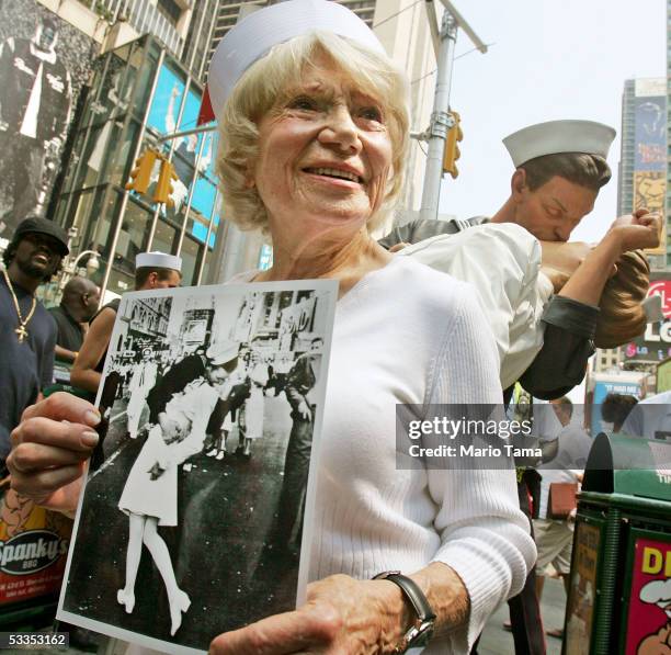 Eighty six-year-old Edith Shain stands in Times Square in front of a statue of her famous kiss with a sailor on V-J Day at the end of World War II...