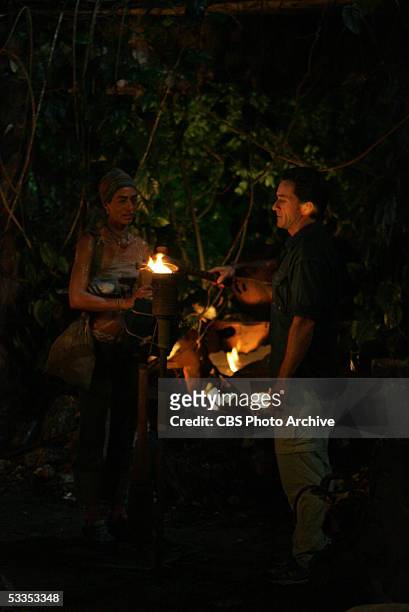 Castaway, Janu Tornell, of the Koror tribe has her torch snuffed out by Jeff Probst, during the 10th episode of Survivor: Palau. Janu quits the game...