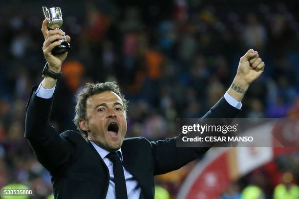 Barcelona's coach Luis Enrique holds a cup as he celebrates after winning the Spanish "Copa del Rey" final match FC Barcelona vs Sevilla FC at the...
