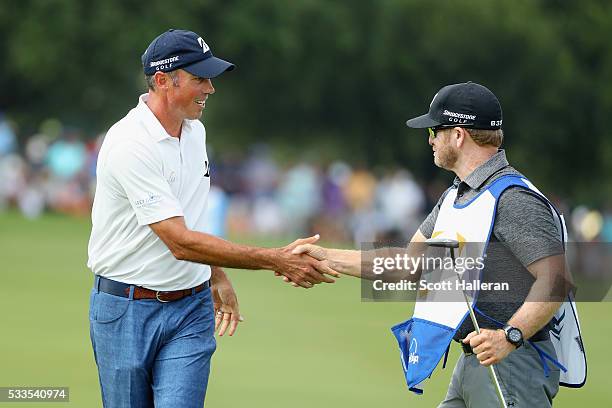 Matt Kuchar shakes hands with his caddie, John Wood, on the 18th green during the Final Round at AT&T Byron Nelson on May 22, 2016 in Irving, Texas.