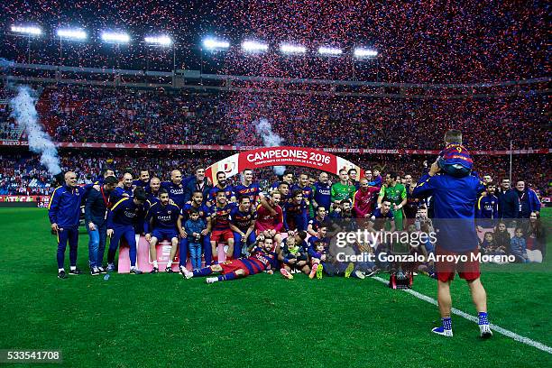 Luis Suarez of FC Barcelona walks with his son in order to pose for a team picture with the trophy after winning the Copa del Rey Final match between...