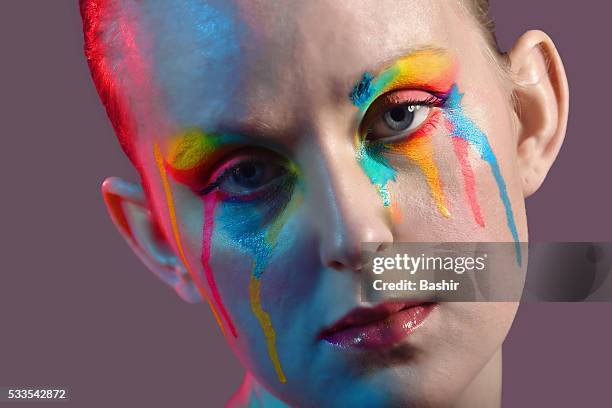 close up portrait of a woman with paint dripping - ゲル効果 ストックフォトと画像