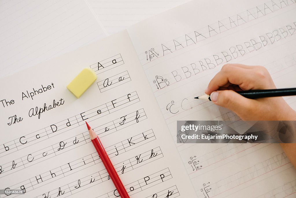 English education concept, alphabet writing practice on notebook