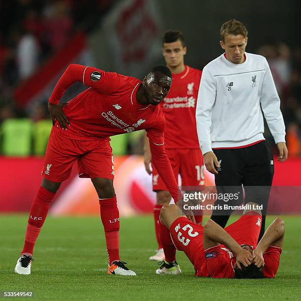 Christian Benteke of Liverpool consoles Emre Can following the UEFA Europa League Final match between Liverpool and Sevilla at St. Jakob-Park on May...
