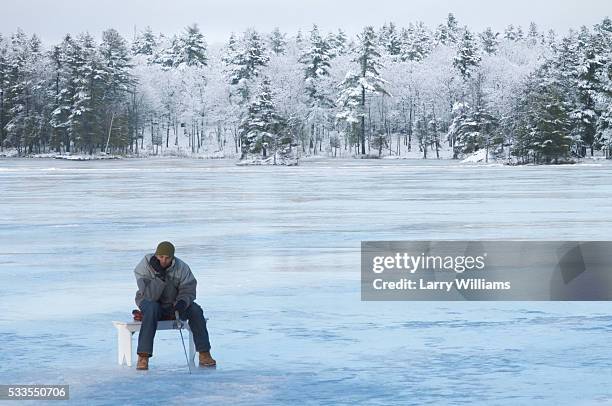 young man ice fishing - ice fishing stock pictures, royalty-free photos & images