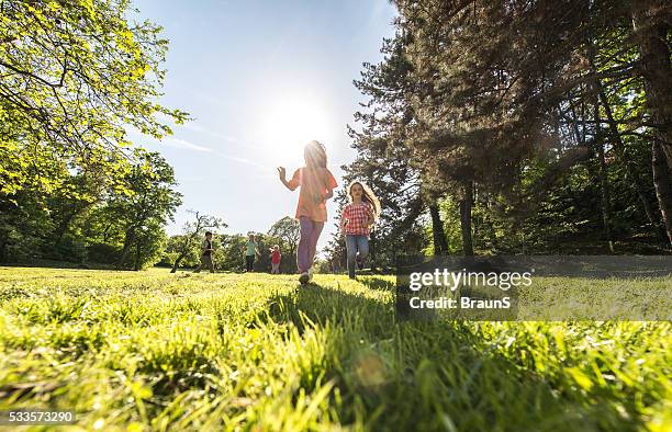 below view of carefree kids having fun in the park. - low angle view grass stock pictures, royalty-free photos & images