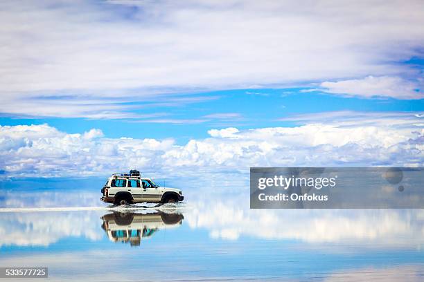 suv auto im salar de uyuni, bolivien - epic film stock-fotos und bilder