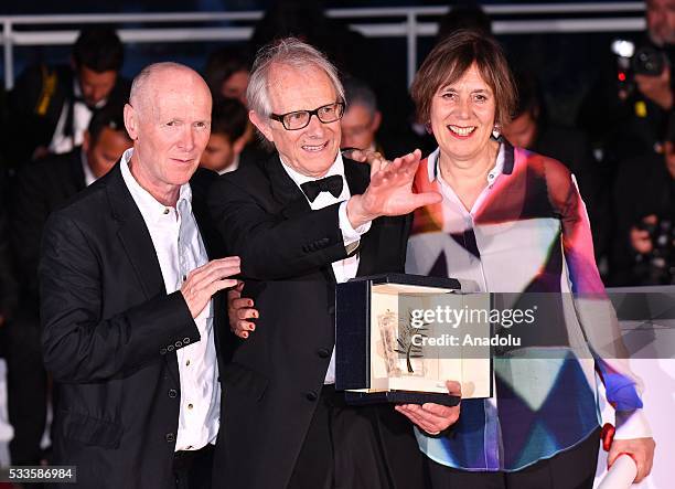 British director Ken Loach poses with British screenwriter Paul Laverty and British producer Rebecca O'Brien after he won Palme d'Or for his movie...