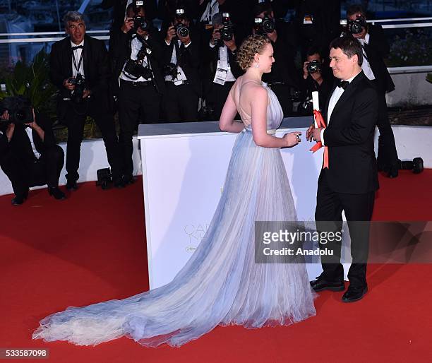 Romanian director Cristian Mungiu poses with Romanian actress Maria Dragus after he received Best Director Award for his movie 'Bacalaureat' during...