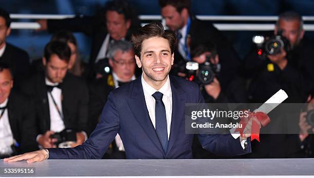 Canadian director Xavier Dolan poses with his Grand Prix award for 'Juste la Fin du Monde' during the Award Winners photocall at the 69th annual...