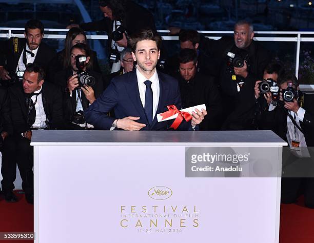 Canadian director Xavier Dolan poses with his Grand Prix award for 'Juste la Fin du Monde' during the Award Winners photocall at the 69th annual...