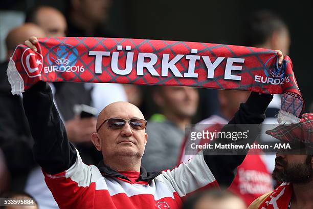 Fan of Turkey holds up a Euro 2016 scarf whilst supporting his team during the International Friendly match between England and Turkey at Etihad...