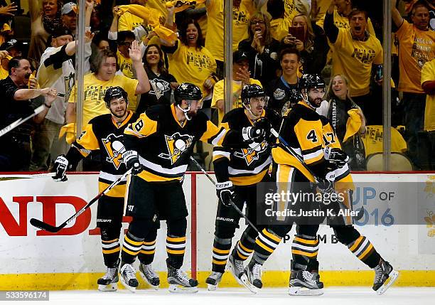 Brian Dumoulin of the Pittsburgh Penguins celebrates with his teammates after scoring a goal against Andrei Vasilevskiy of the Tampa Bay Lightning...