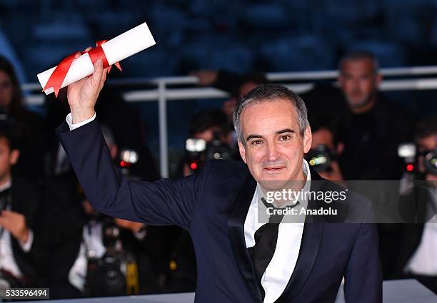 French director Olivier Assayas poses as the Best Director Award for his movie 'Personal Shopper' during the Award Winners photocall at the 69th...