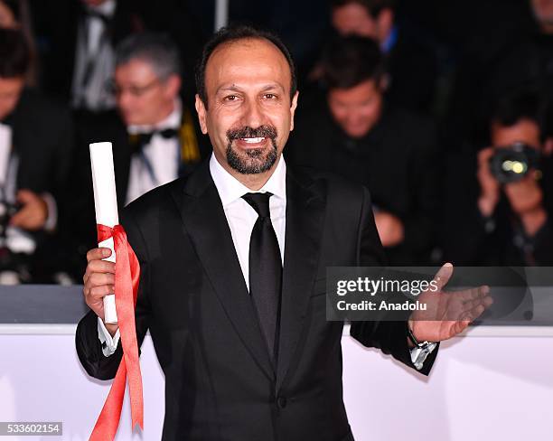 Iranian director Ashgar Farhadi poses as the Best Screenplay award for his movie 'Forushande' during the Award Winners photocall at the 69th annual...