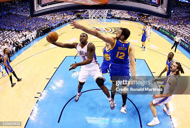 Dion Waiters of the Oklahoma City Thunder goes up against Andrew Bogut of the Golden State Warriors in the first half in game three of the Western...