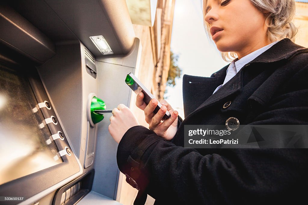 Woman with credit card withdraw money