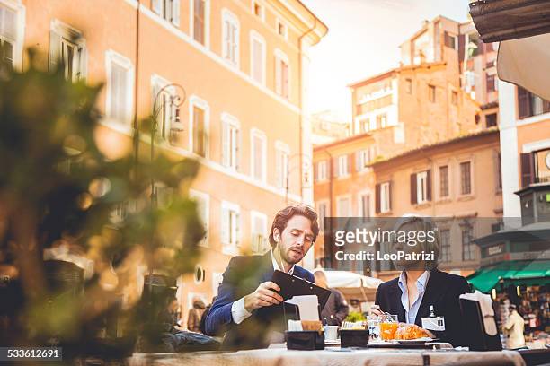 business couple taking a break - italian cafe stock pictures, royalty-free photos & images