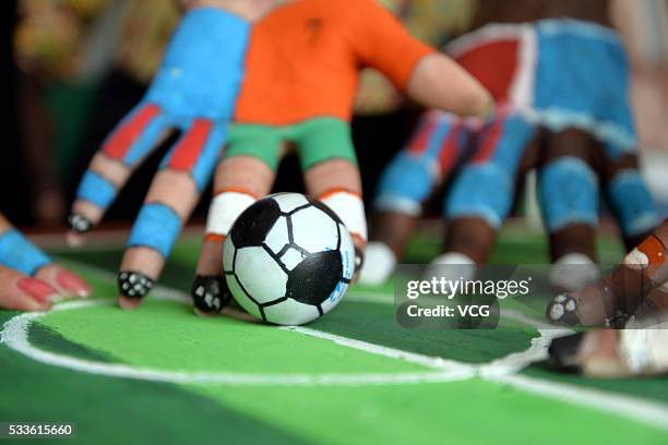 Students use their painted fingers to play kick soccer during a competition at Liaocheng University on May 22, 2016 in Liaocheng, Shandong Province...