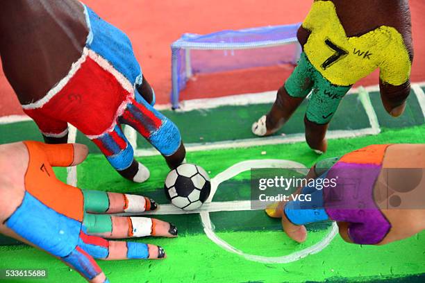 Students use their painted fingers to play kick soccer during a competition at Liaocheng University on May 22, 2016 in Liaocheng, Shandong Province...